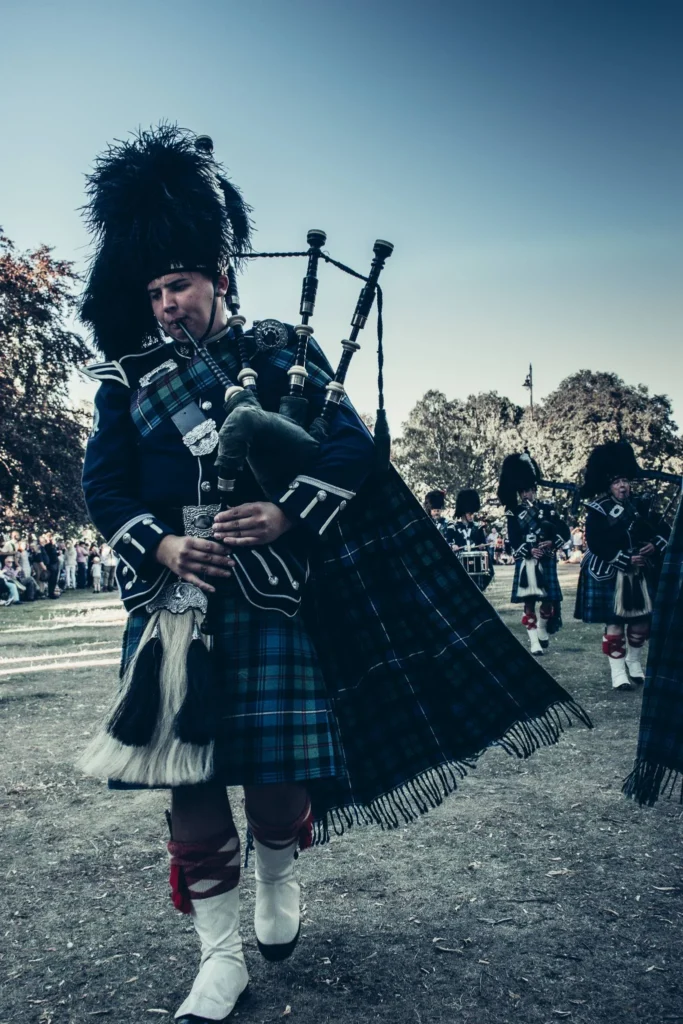 Scottish bagpiper in traditional costume at the Ballater Highland Games