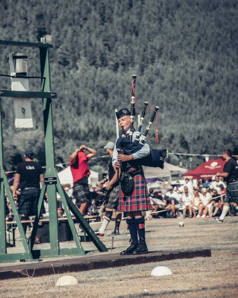 Bagpiper in kilt in full competition at the Highland Games