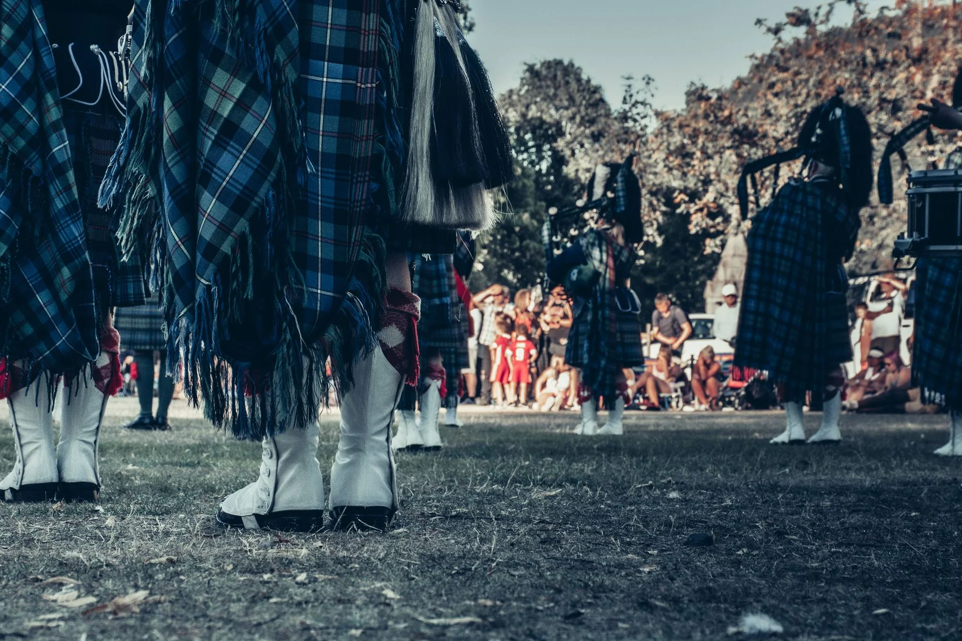 Group of bagpipers in traditional Scottish clan kilts