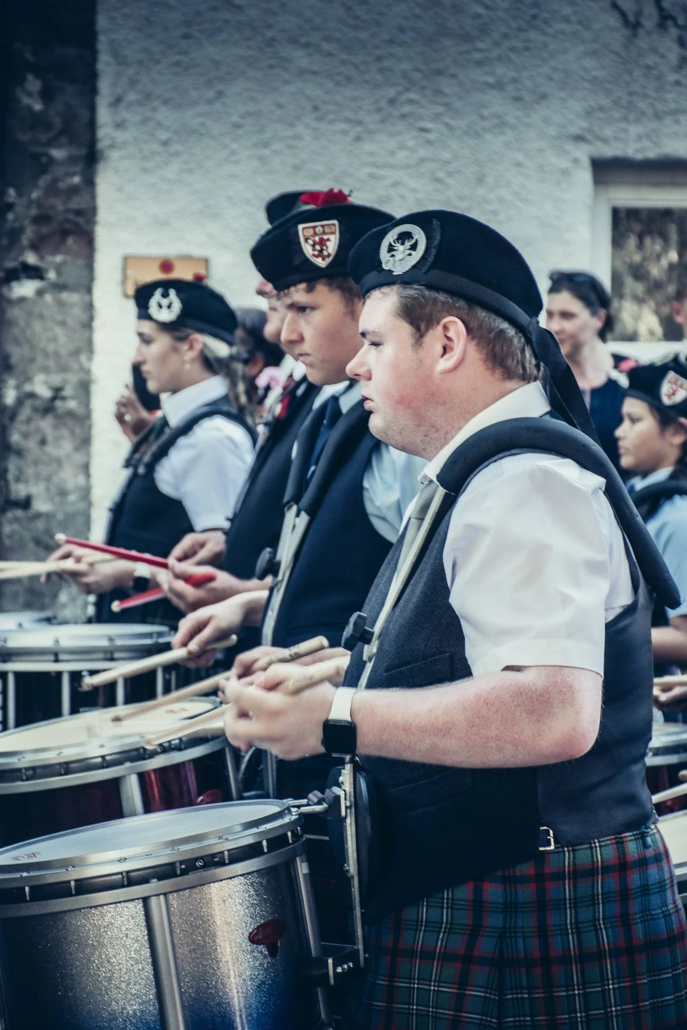 Musicians in traditional Scottish attire play the drum at the Highland Games