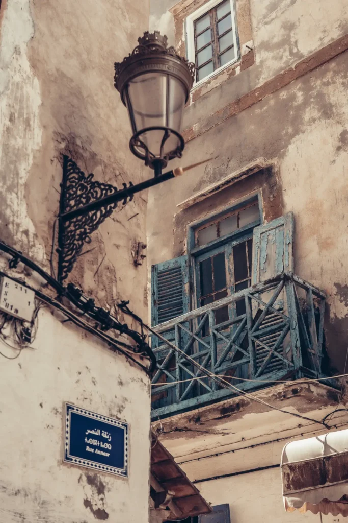 Old medina of Marrakech with wooden balcony and hanging lantern.