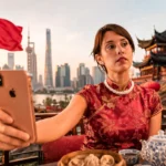 Caroline with a smartphone in front of an iconic monument in China