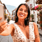 Smiling traveller taking a selfie in a colourful Colombian street