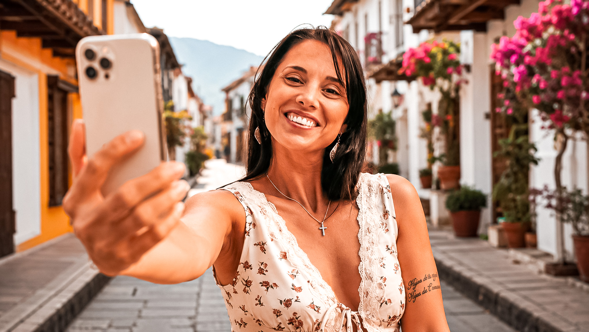 Smiling traveller taking a selfie in a colourful Colombian street