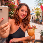 Smiling traveller taking a selfie in a colourful Mexican street