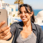 Smiling traveller taking a selfie in Sidi Bou Said, Tunisia