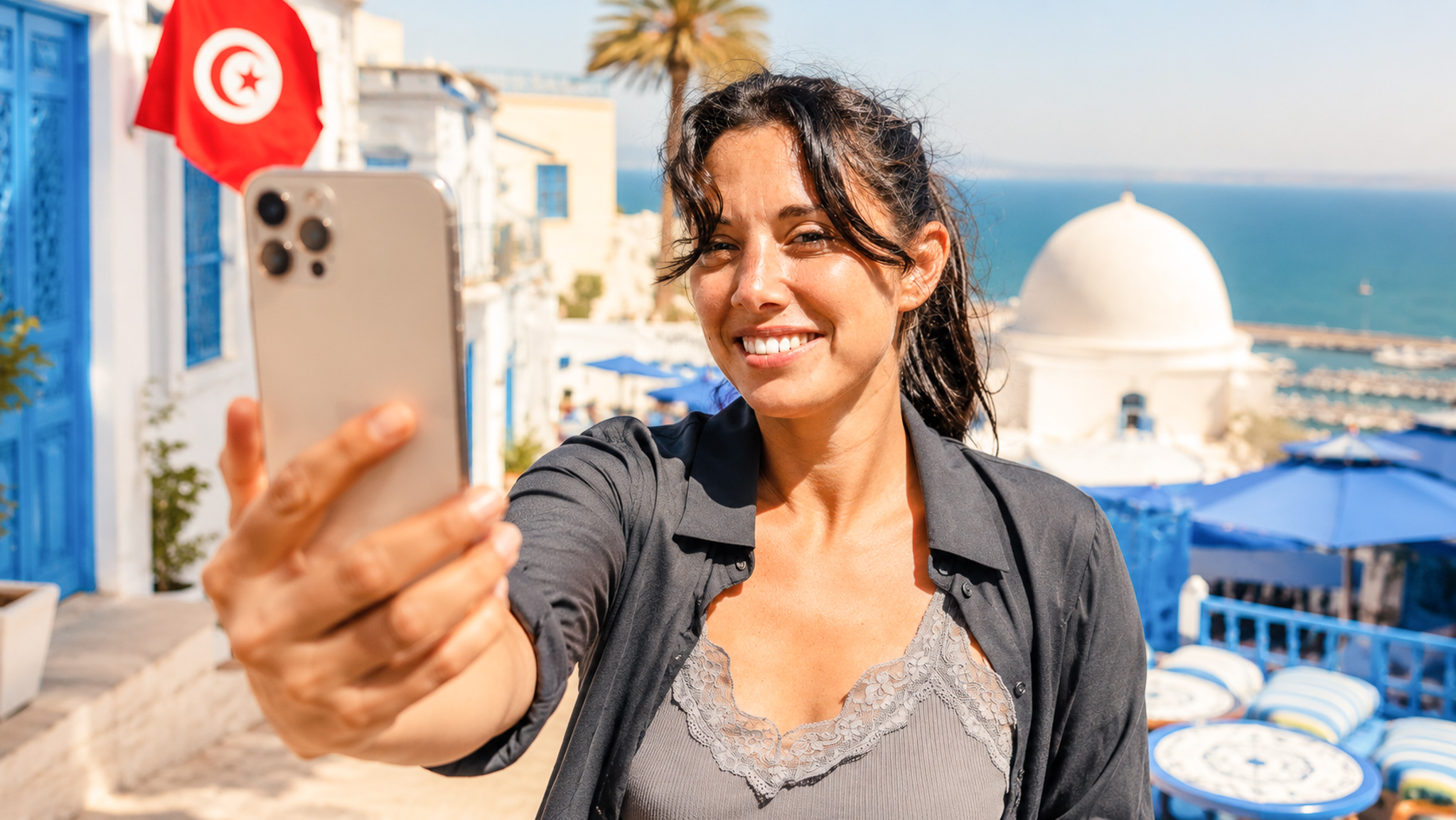 Smiling traveller taking a selfie in Sidi Bou Said, Tunisia