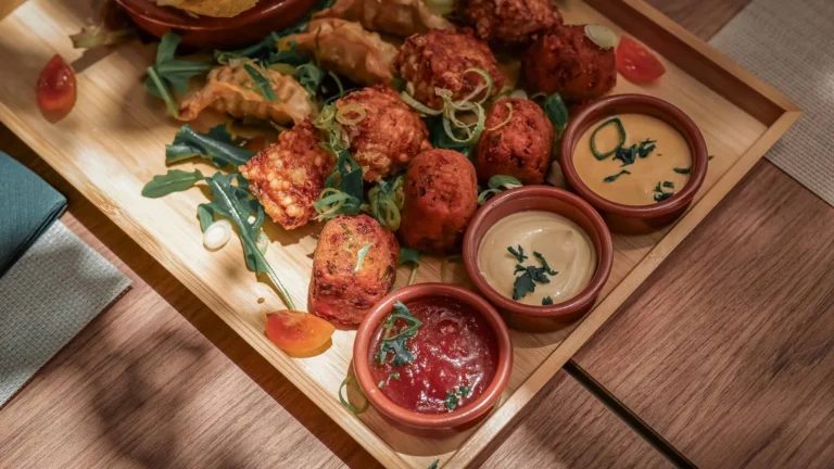 Assortment of traveling mezze at Coisa Linda in Tavira: Bangladeshi specialty, Brazilian tapioca dadinhos, pork gyozas and sun-dried tomato hummus
