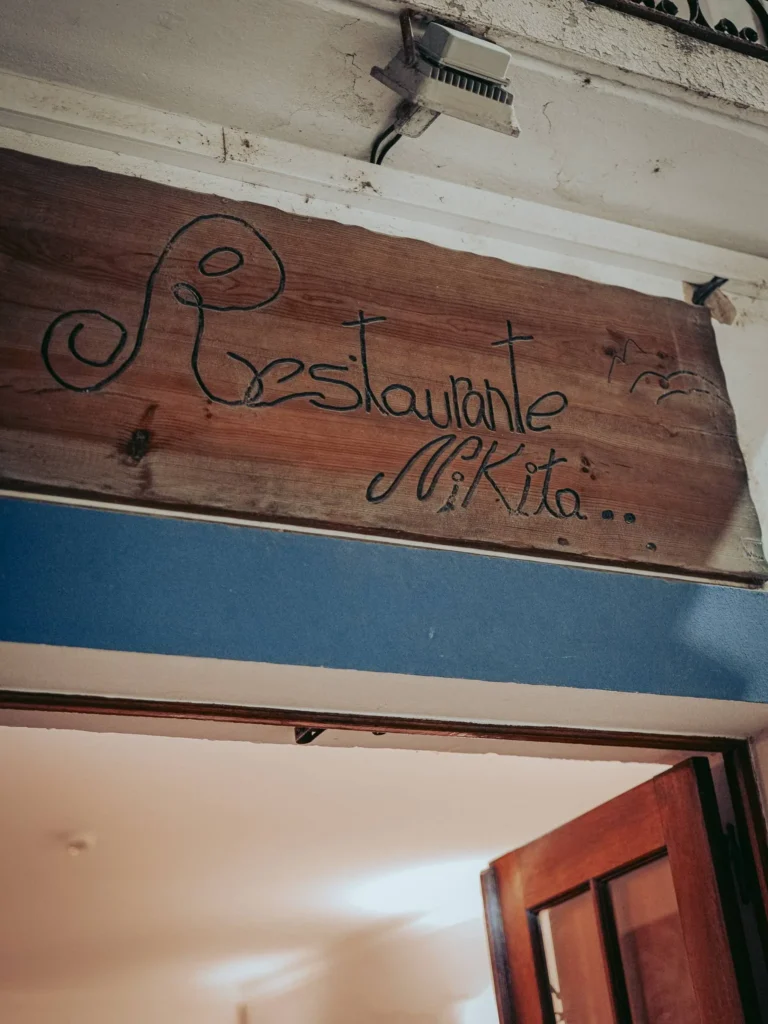 Wooden sign of Nikita restaurant at its entrance in Tavira, Algarve, Portugal