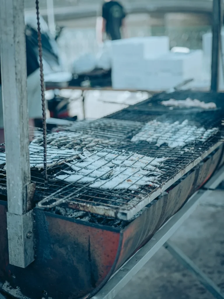 First sardines of the season in coarse salt grilled over embers for São João in Tavira