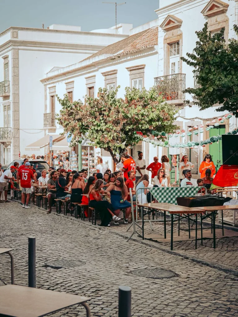 Long tables and jerseys from Portugal in a cobbled square in Tavira during Saint John's Day