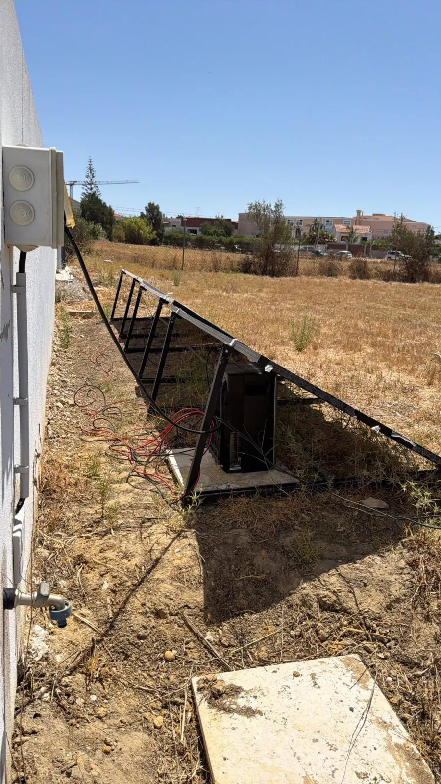 EcoFlow Stream battery placed outdoors under a solar panel, in the shade, in an outdoor setup