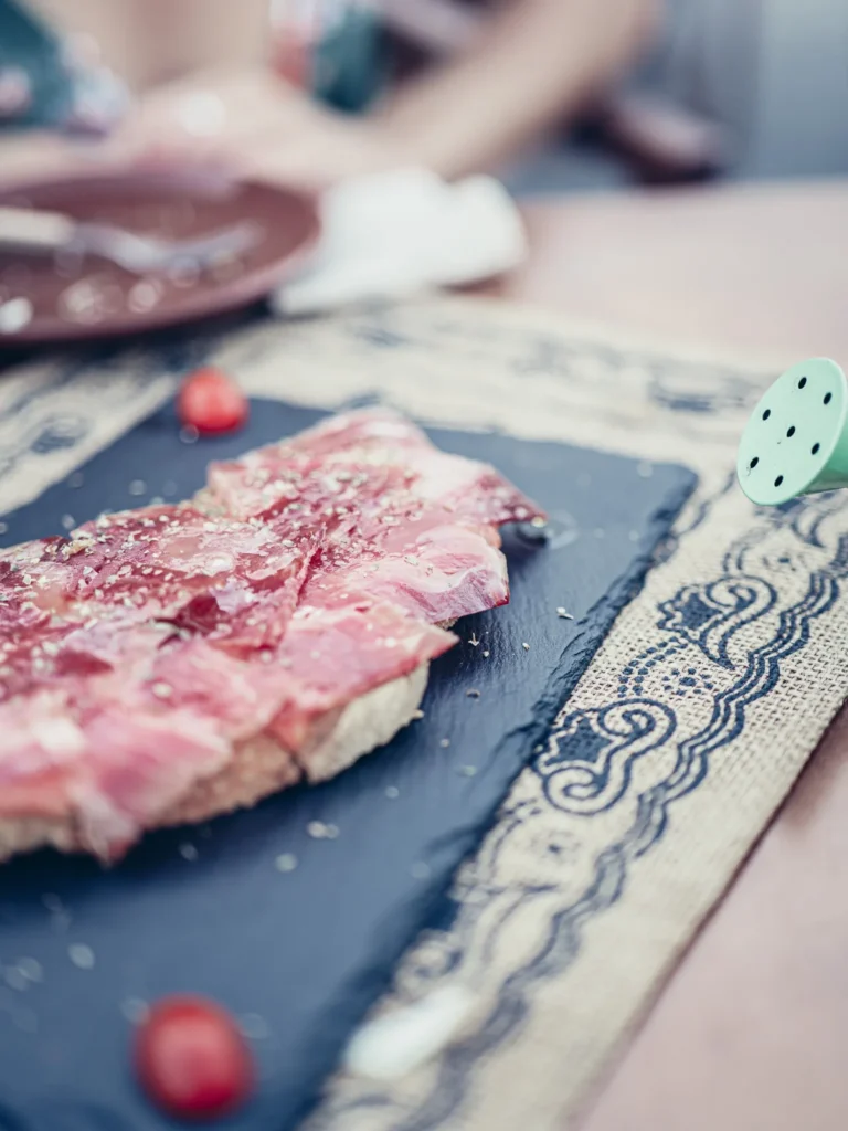Iberian presunto tartine on homemade bread, served on a slate at Bodeguita Salinas in Tavira, Algarve.