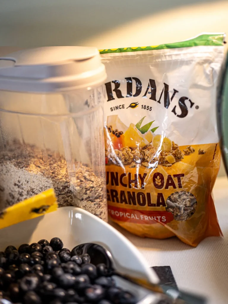 Bowl of fresh blueberries placed next to a pack of Jordans granola and a container of cereal, on a table at Rocklee Bnb in the Scottish Highlands in August.