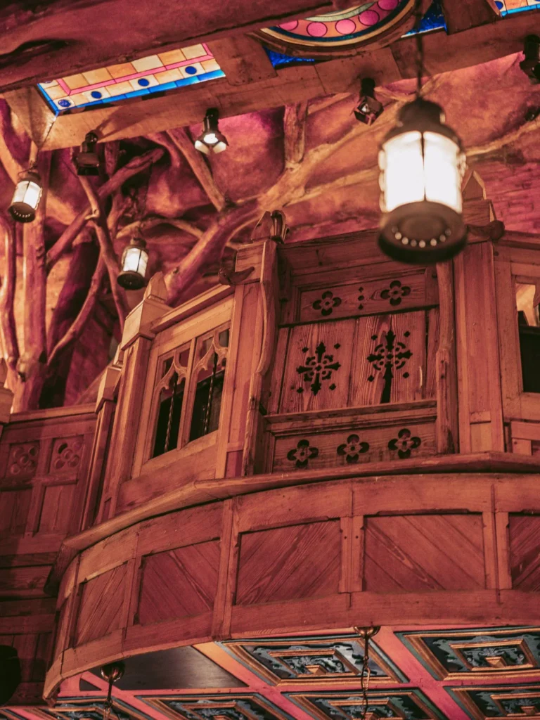 Carved wooden balcony and coloured stained glass inside Waxy O'Connor's pub in Glasgow.