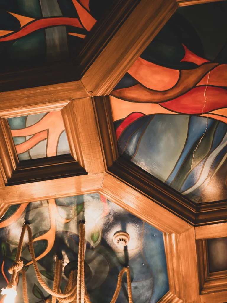 Decorative wooden ceiling, stained glass, and ropes of the Waxy O'Connor's pub in Glasgow
