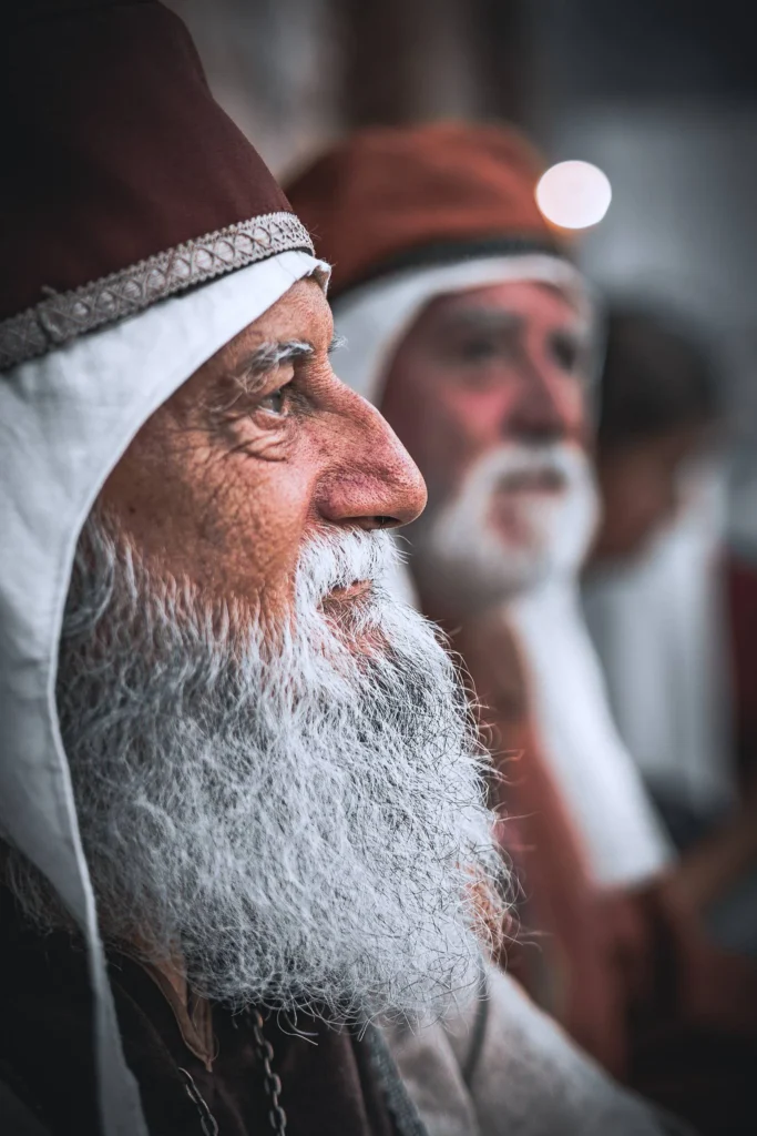 Two men dressed in medieval costumes are photographed up close during a festival in Castro Marim, Algarve, in August 2023.