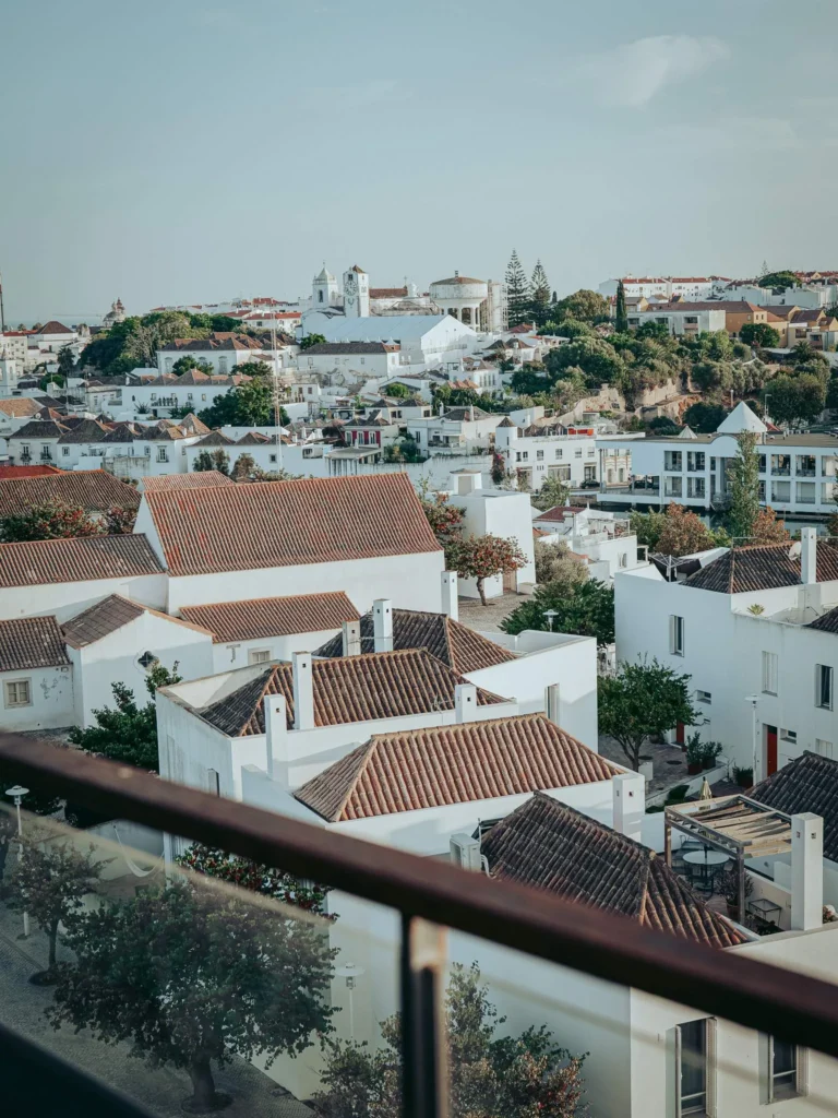 View of the rooftops and the historic center of Tavira from the terrace of the Nomad, with the church bell tower standing out in the background.